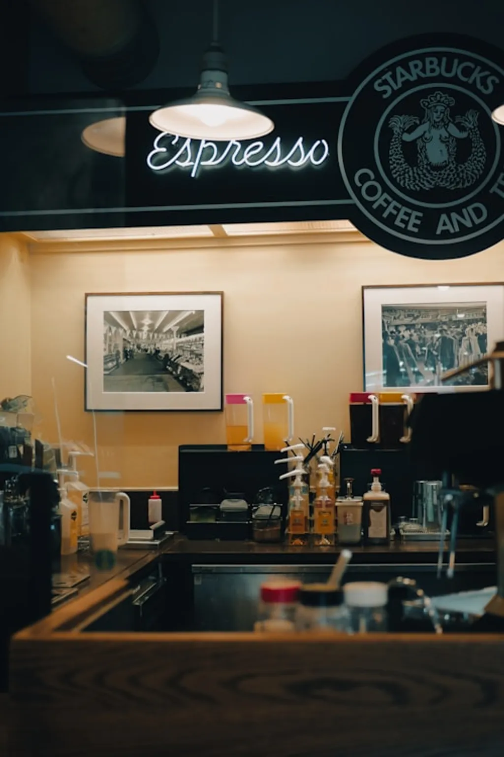 a coffee shop with a neon sign above the counter